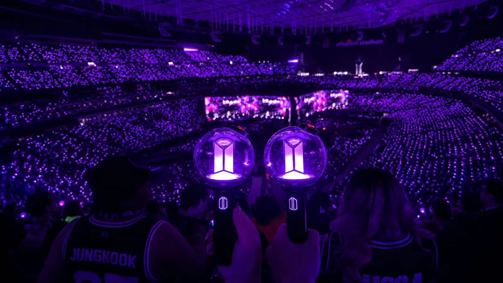 BTS Army fans holding purple lightsticks at concert representing Indian KPOP creator fandom culture